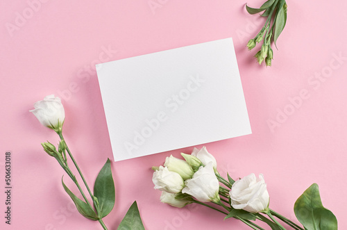 Invitation or greeting card mockup with white eustoma flowers on pink