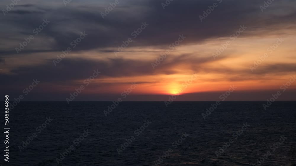 Sea sunset horizon. Dark blue water. fast movement. strong wind. Menacing purple storm clouds. Orange sunset light. The concept of solitude, depression, longing, memories. Travel, tourism holidays Sea sunset horizon. Dark blue water. fast movement. strong wind. Menacing purple storm clouds. Orange sunset light. The concept of solitude, depression, longing, memories. Travel, tourism holidays