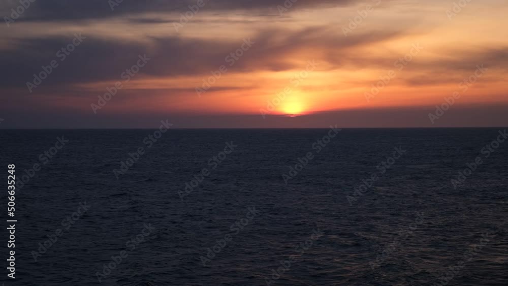 Sea sunset horizon. Dark blue water. fast movement. strong wind. Menacing purple storm clouds. Orange sunset light. The concept of solitude, depression, longing, memories. Travel, tourism holidays Sea sunset horizon. Dark blue water. fast movement. strong wind. Menacing purple storm clouds. Orange sunset light. The concept of solitude, depression, longing, memories. Travel, tourism holidays