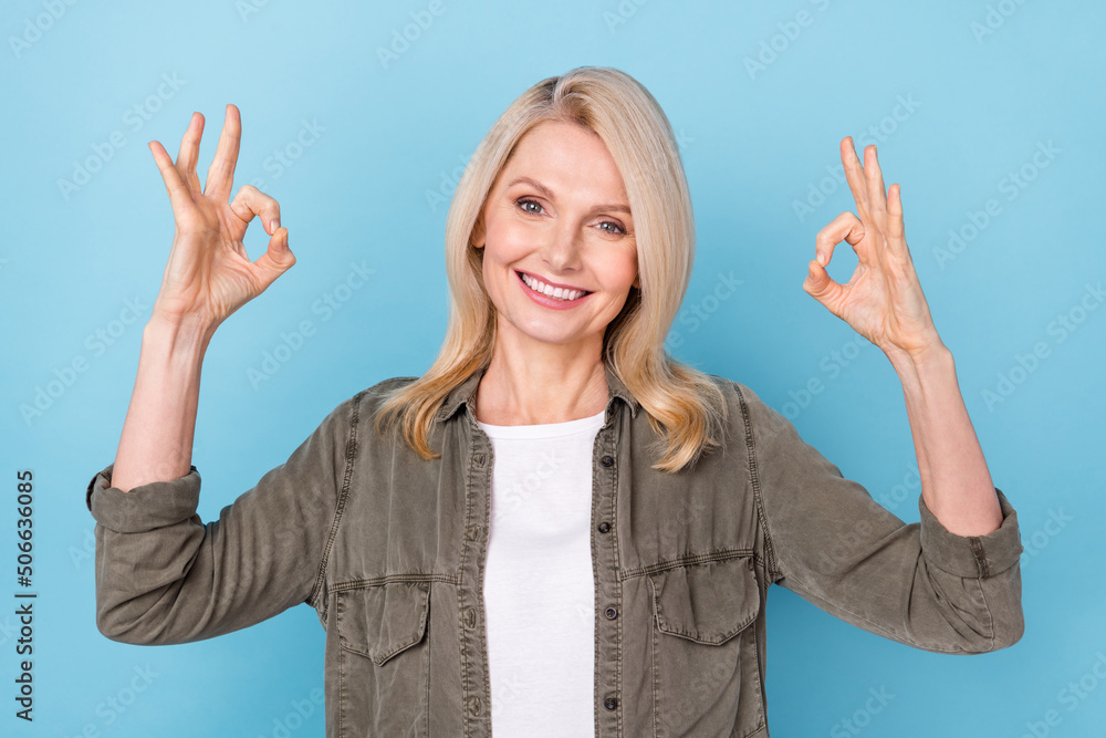 Photo of positive successful middle aged lady make okay symbol like perfect promo isolated blue pastel color background Photo of positive successful middle aged lady make okay symbol like perfect promo isolated blue pastel color background