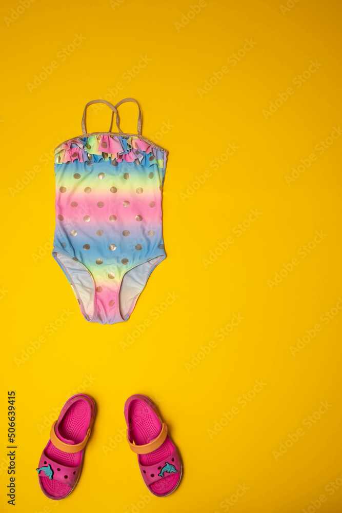 Summer vacation flatlay kids swimsuit and beach sandals