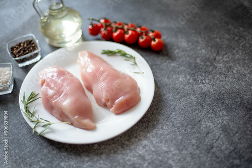 Raw chicken fillet on stone background with copy space for your text