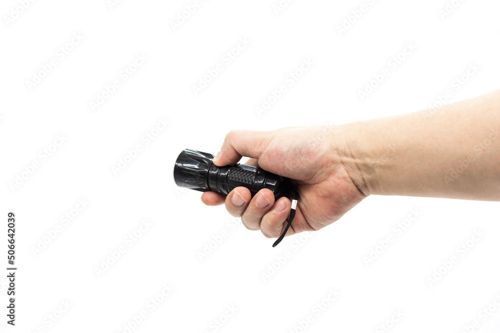 Closeup of hand holding small black flashlight isolated on white background Closeup of hand holding small black flashlight isolated on white background