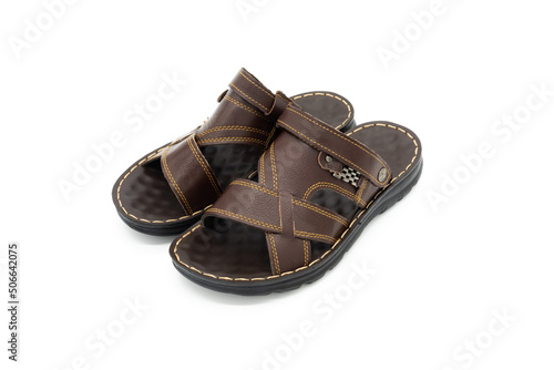 Pair of brown leather fashion slippers closeup on white background