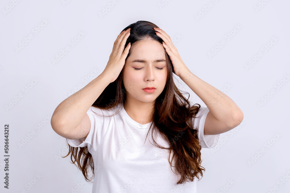 Young asian beautiful woman hand touching head she's feeling depressed stress headache be tired from working on isolated white background. She has symptom office syndrome. Young asian beautiful woman hand touching head she's feeling depressed stress headache be tired from working on isolated white background. She has symptom office syndrome.
