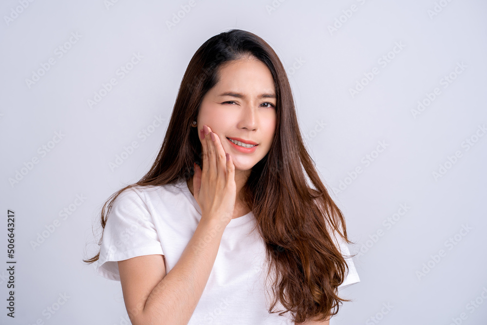 Young asian woman isolated on white background having a strong teeth pain, molar ache. Young asian woman isolated on white background having a strong teeth pain, molar ache.