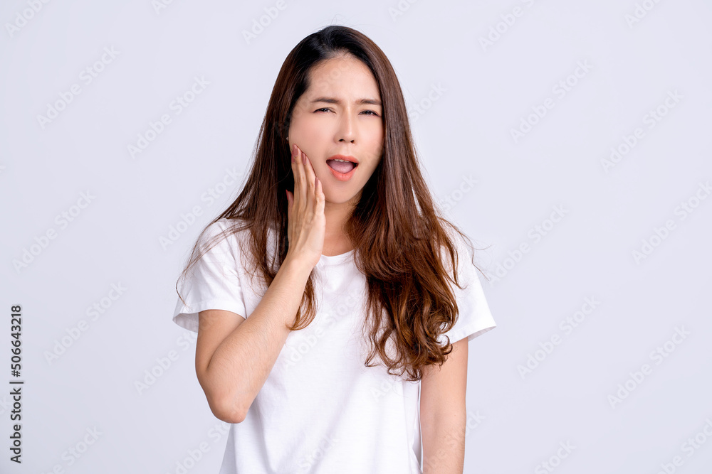 Young asian woman have tooth pain on white studio background. Toothache, dental problems, stomatology and medicine concept Young asian woman have tooth pain on white studio background. Toothache, dental problems, stomatology and medicine concept