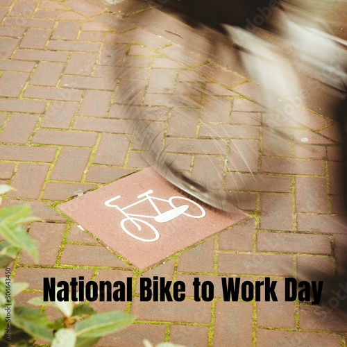 Digital composite image of national bike to work day text by blurred bicycle on sign over footpath