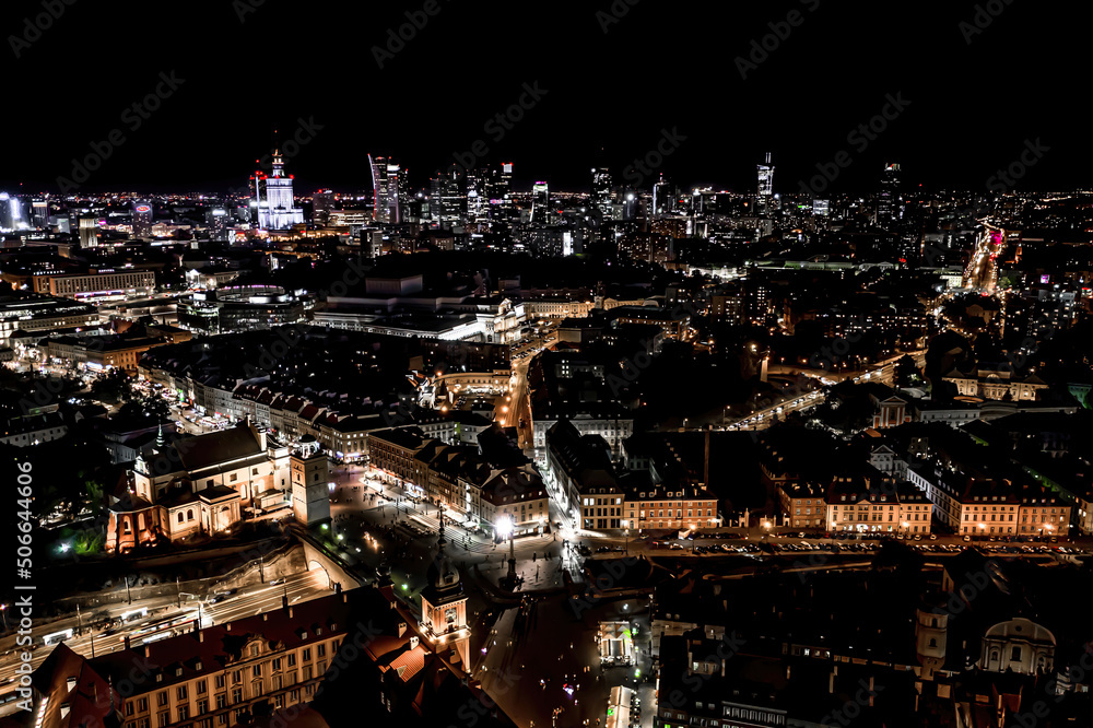Aerial view of old buildings, castles and a church in the old city of Warsaw. Cityscape of old buildings and architecture in the old town in Warsaw. Night time