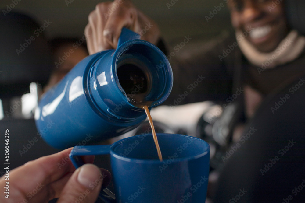 POV close up man pouring coffee from thermos into cup POV close up man pouring coffee from thermos into cup