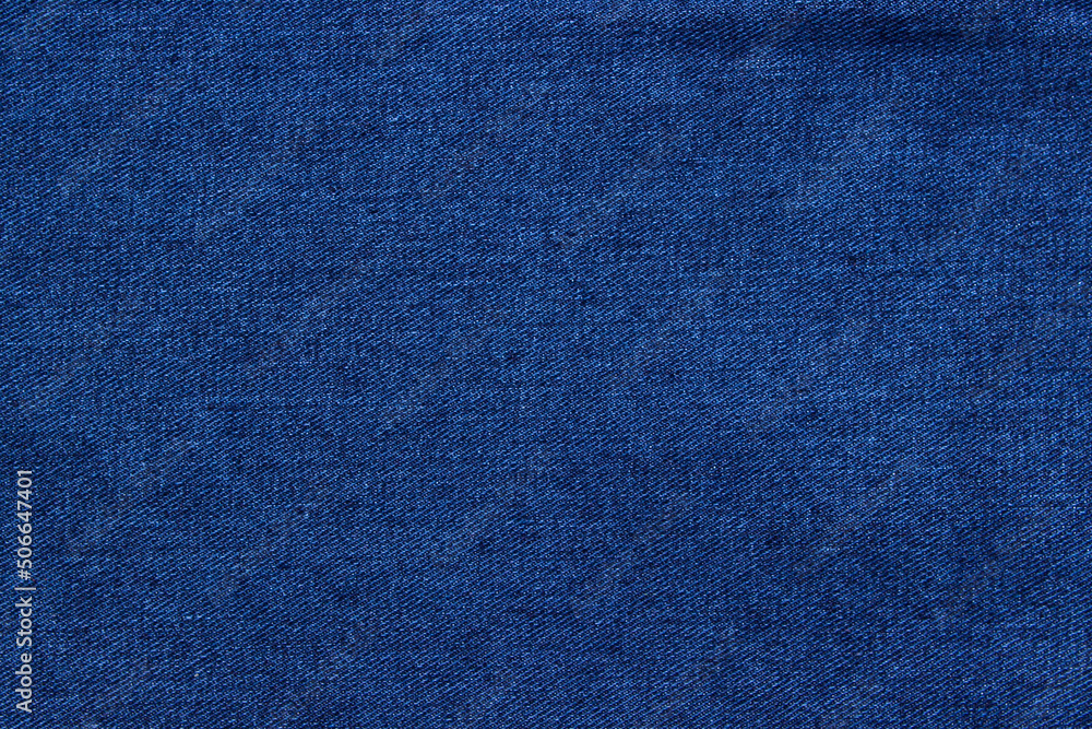 Texture of blue denim close-up. Modern high-quality material for clothes. Texture of blue denim close-up. Modern high-quality material for clothes.