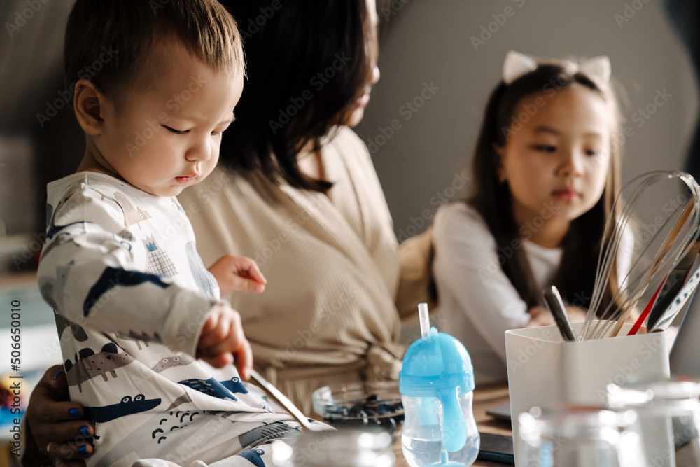 Asian boy playing while spending time with her family