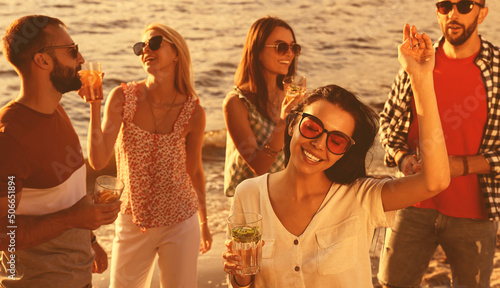 Photography Woman with friends having fun near river at summer party