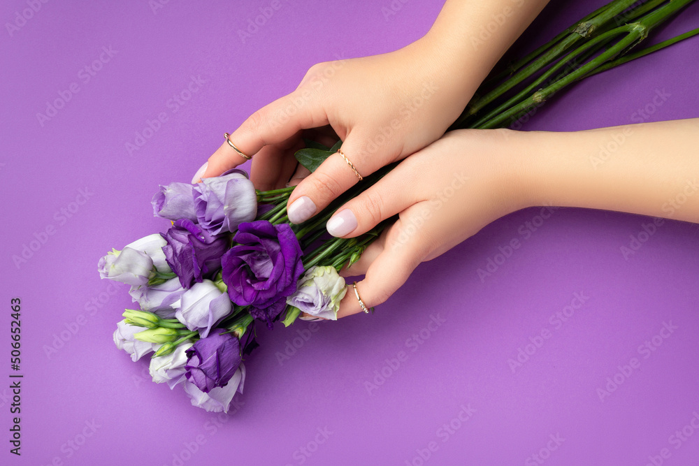 Beautiful womans hands with spring summer design on violet background. Manicure, pedicure beauty salon concept
