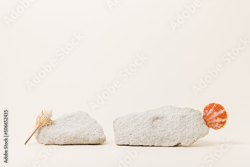 Empty stone podiums with seashells, displays for summer product and cosmetic presentation