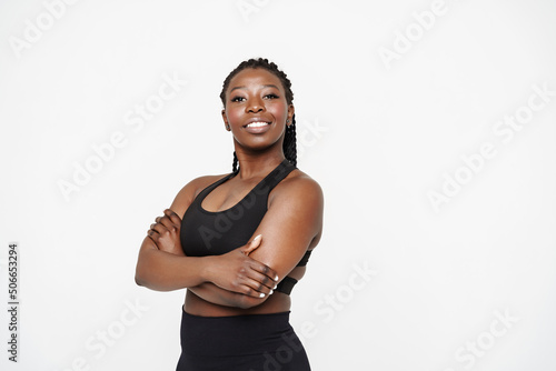Canvastavla Young black sportswoman with afro pigtails smiling and looking aside