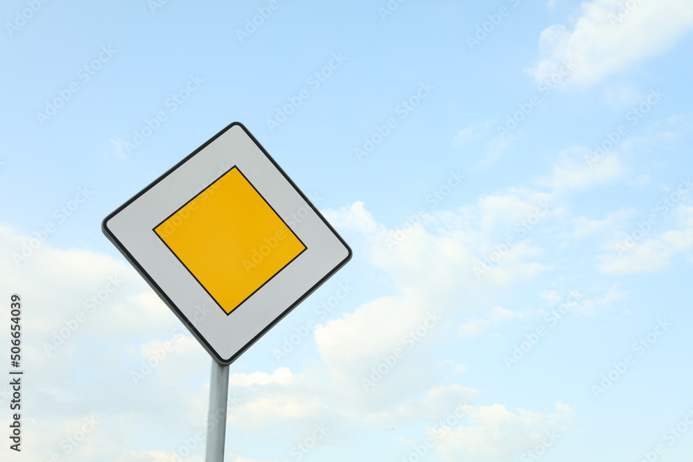 Traffic sign Priority Road against blue sky. Space for text