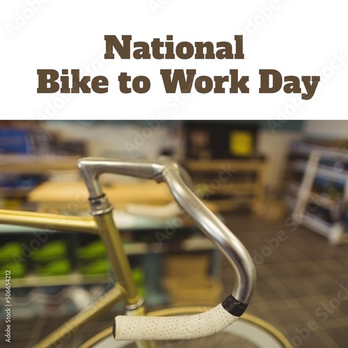 Composite image of bicycle handle with national bike to work day text in workshop