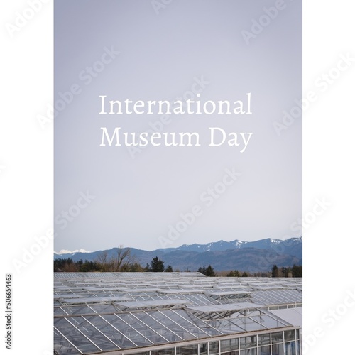 Composite of greenhouse glass building and international museum day text against clear sky