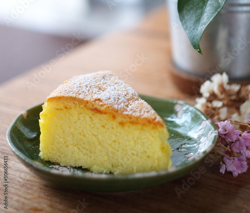 Japanese cotton cheesecake on wood table with powdered sugar on top. Selective focus