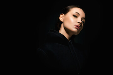 beautiful young woman in dark studio. pretty girl