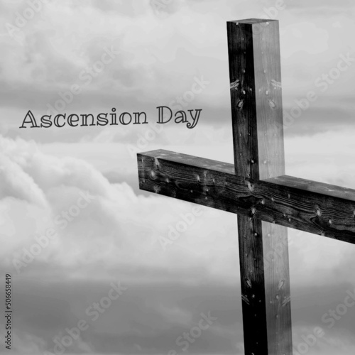 Ascension day text with wooden cross against cloudy sky, copy space
