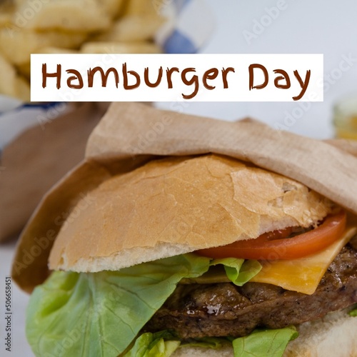 Close-up of hamburger day text over burger in plate, copy space