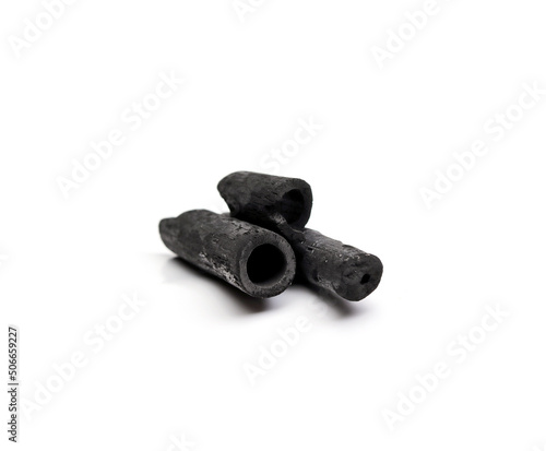 Black bamboo charcoal sticks are placed on a white background.