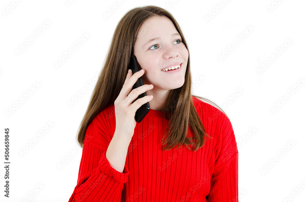 Adorable smiling teenage girl talking on the phone. Charming young girl talking on the phone looking up. Isolated on white background Adorable smiling teenage girl talking on the phone. Charming young girl talking on the phone looking up. Isolated on white background