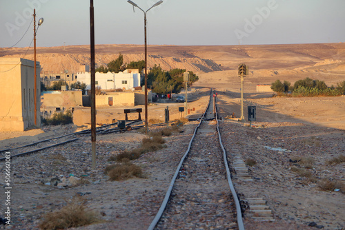 Jordan - Al Hasa - The rails of Hejaz railway going far to the desrt hills away from abandoned station Al-Hasa at sunset photo