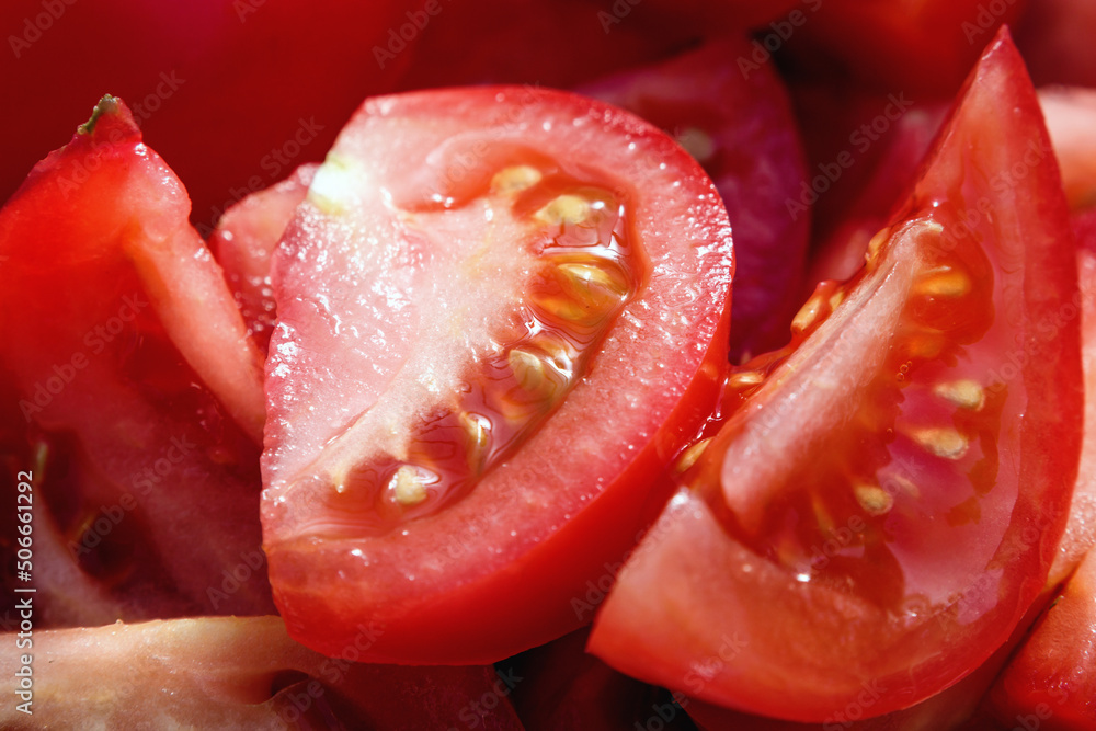 Sliced tomato slices. Red tomato background close-up Sliced tomato slices. Red tomato background close-up