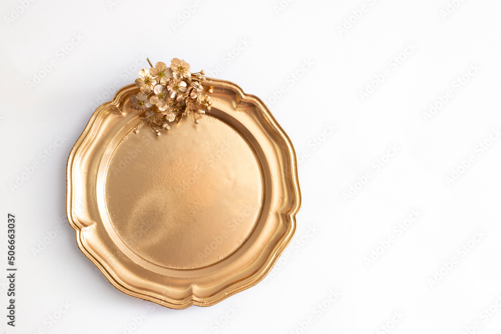 round golden tray with metallic flower isolated on white background round golden tray with metallic flower isolated on white background
