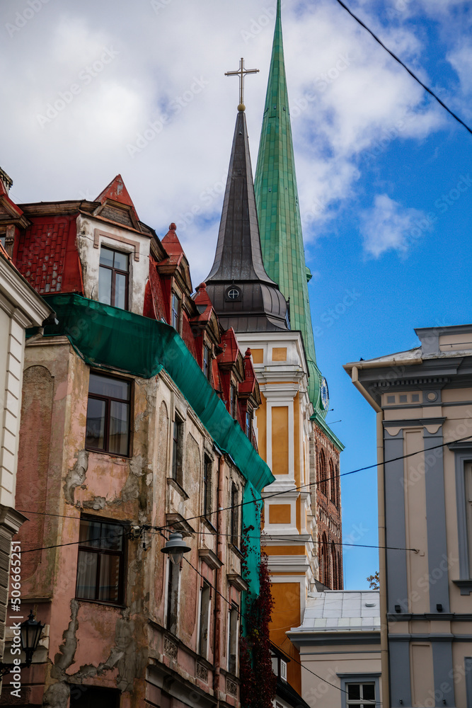 Obraz premium Riga, Latvia, 14 October 2021: St. James's Cathedral, Lutheran and Orthodox Church with bell tower, Northern Gothic Style with Red brick, recognizable medieval landmark at old town at sunny day
