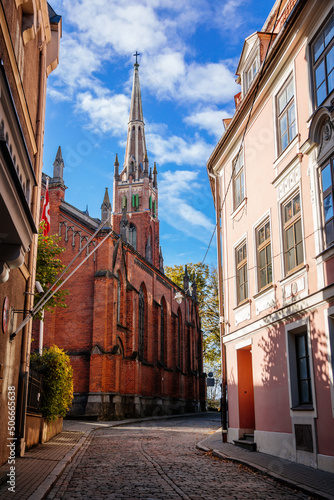Riga, Latvia, 19 October 2021: neo-Gothic St. Saviour's church designed by Johann Felsko for English speaking congregation, Red brick, recognizable medieval landmark at old town at sunny day