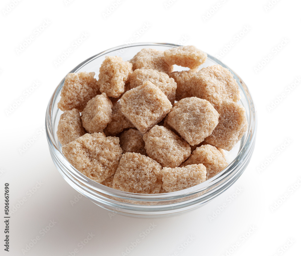 Cubes of brow cane sugar in glass bowl isolated on white background with clipping path Cubes of brow cane sugar in glass bowl isolated on white background with clipping path