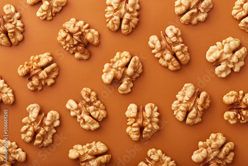 Wallnuts pattern viewed from above on a orange background. Top view © virtustudio