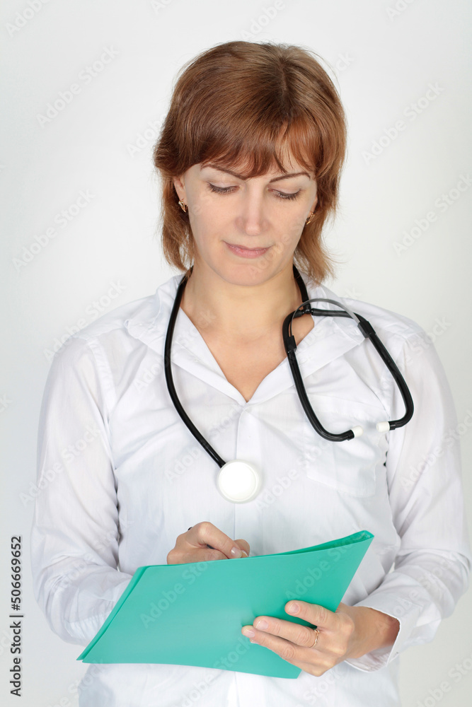 Portrait of a female doctor in a white uniform in the studio on a white background Portrait of a female doctor in a white uniform in the studio on a white background