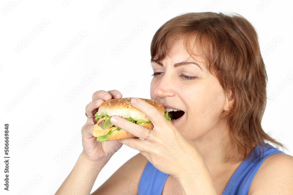 Portrait of young beautiful hungry woman eating burger. Diet concept. Portrait of young beautiful hungry woman eating burger. Diet concept.