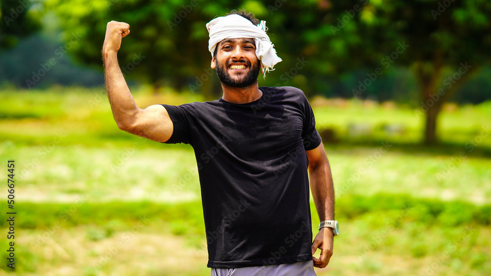 Fototapeta premium succeed indian young farmer boy with his land in village