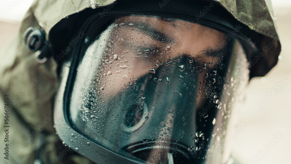 Fototapeta premium man with gas mask under the rain