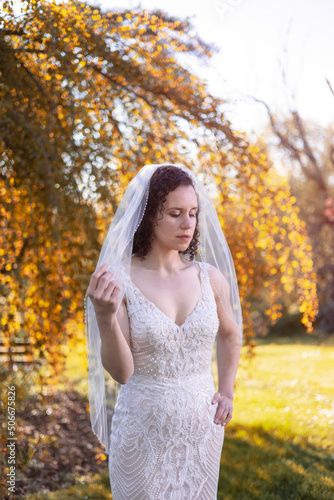 White Caucasian Adult Woman in a Wedding Dress standing outside in nature. Queen Elizabeth Park, Vancouver, British Columbia, Canada. Bride