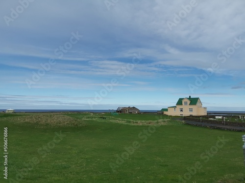 A house on the middle of green grass peaceful iceland roadtrip island vacation