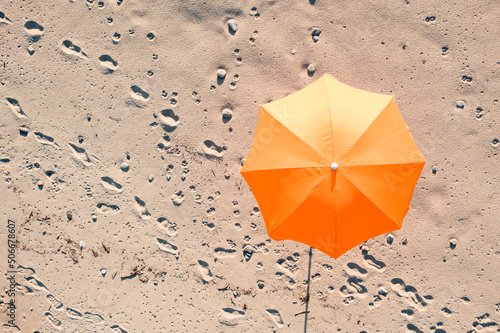 Beach umbrella on white sand