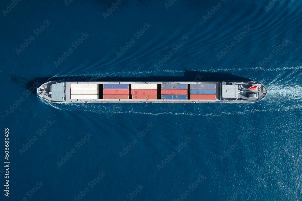 Aerial top view of cargo container ship. Huge cargo ship crossing the ocean. Concept freight shipping ship. Large Container Ship at Sea, Aerial Top Down View.