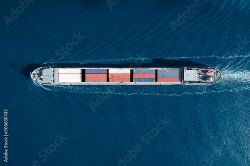 Aerial top view of cargo container ship. Huge cargo ship crossing the ocean. Concept freight shipping ship. Large Container Ship at Sea, Aerial Top Down View. 