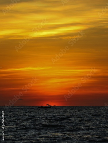 dark orange sky over the ocean after sunset © Abdul Rahman