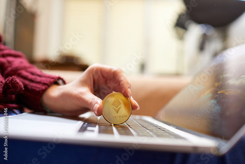 Hand holding golden bitcoin ethereum