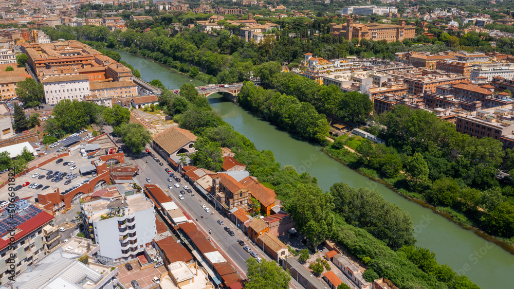 Aerial view of the Tiber River in Rome, Italy, during a beautiful sunny summer day. In the foreground the Testaccio district.