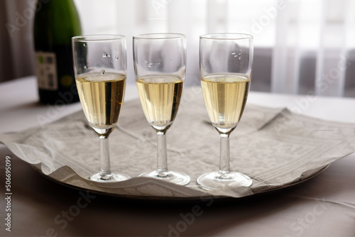 Three glasses of chmpagne on table at restaurant