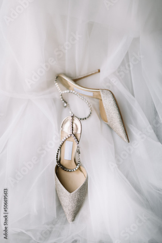 stylish wedding shoes with veil on a background 
wedding flat lay